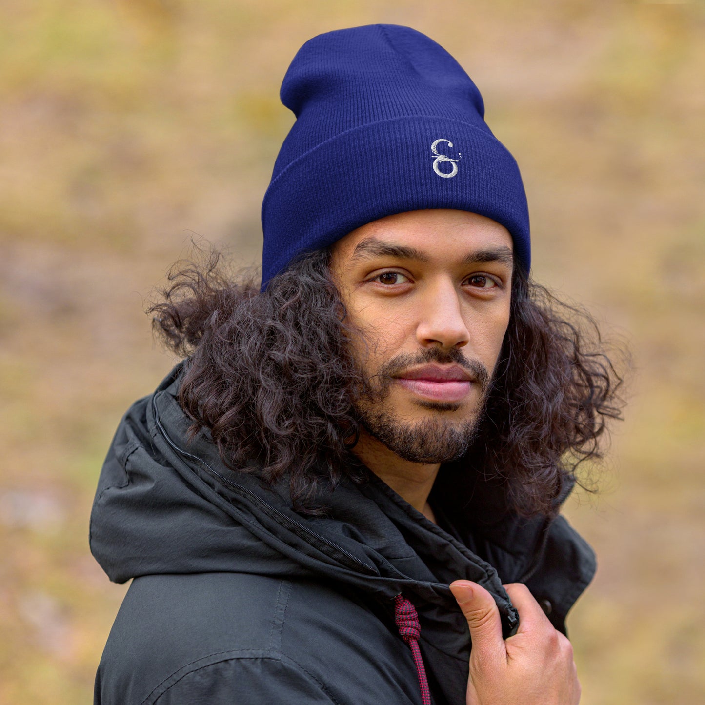 Gorro unisex de punto en color azúl con el logo de Símera bordado al frente, modelo masculino mostrando el diseño.